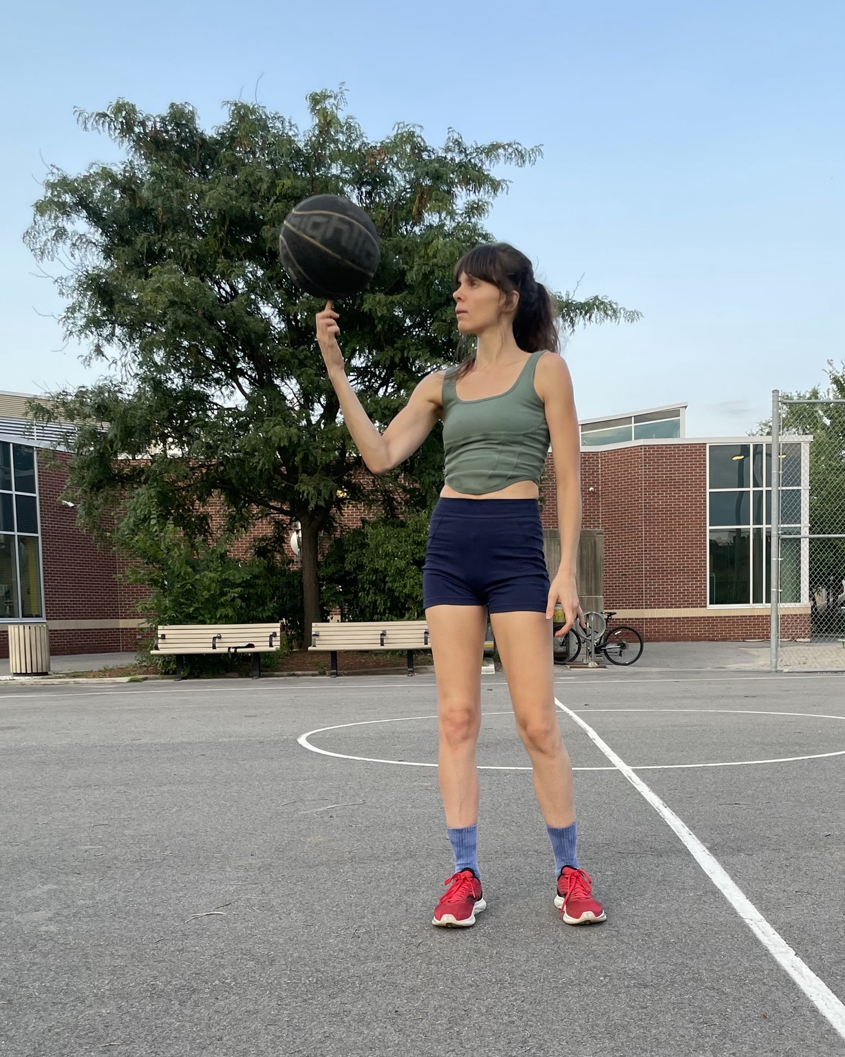 Rozalia playing basketball outdoors in Ottawa as part of her active holistic wellness practice